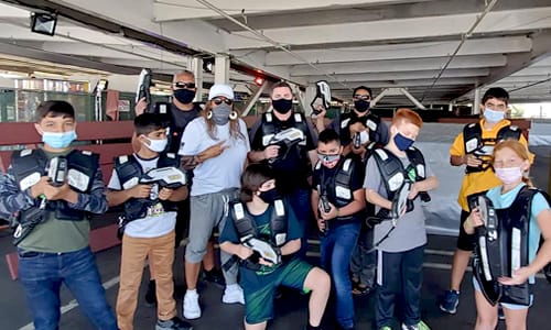 Group posing with Laser tag equipment
