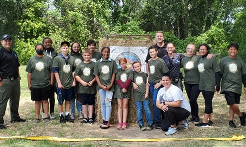 Group picture of people at archery range.