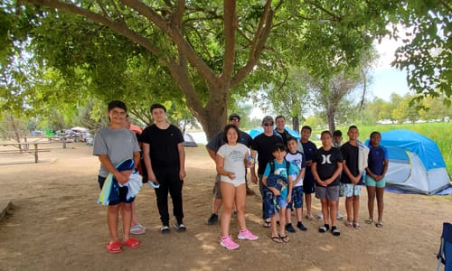 Kids standing ready to start camping trip