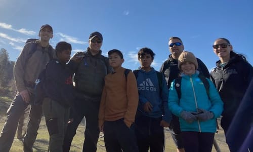 Group of kids and adults posing in front of folsom lake