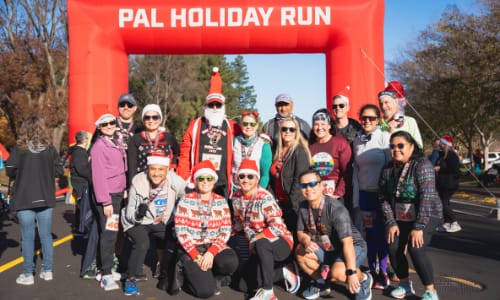 Group of runners posing at finish line