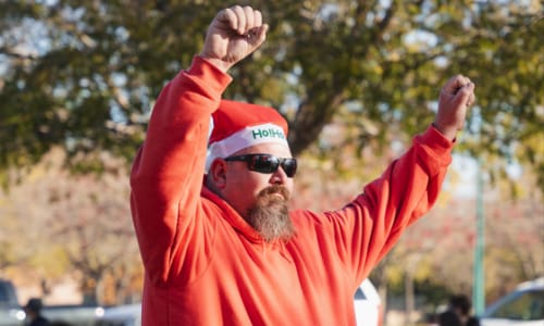 Man pumping fists while running