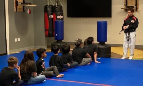 Students listening to Grandmaster Kidong Lee.