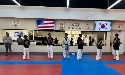 Students lined up on mat.