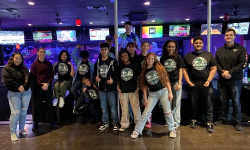 Child being helped with bicycle