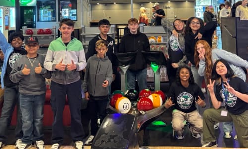 Child being helped with bicycle